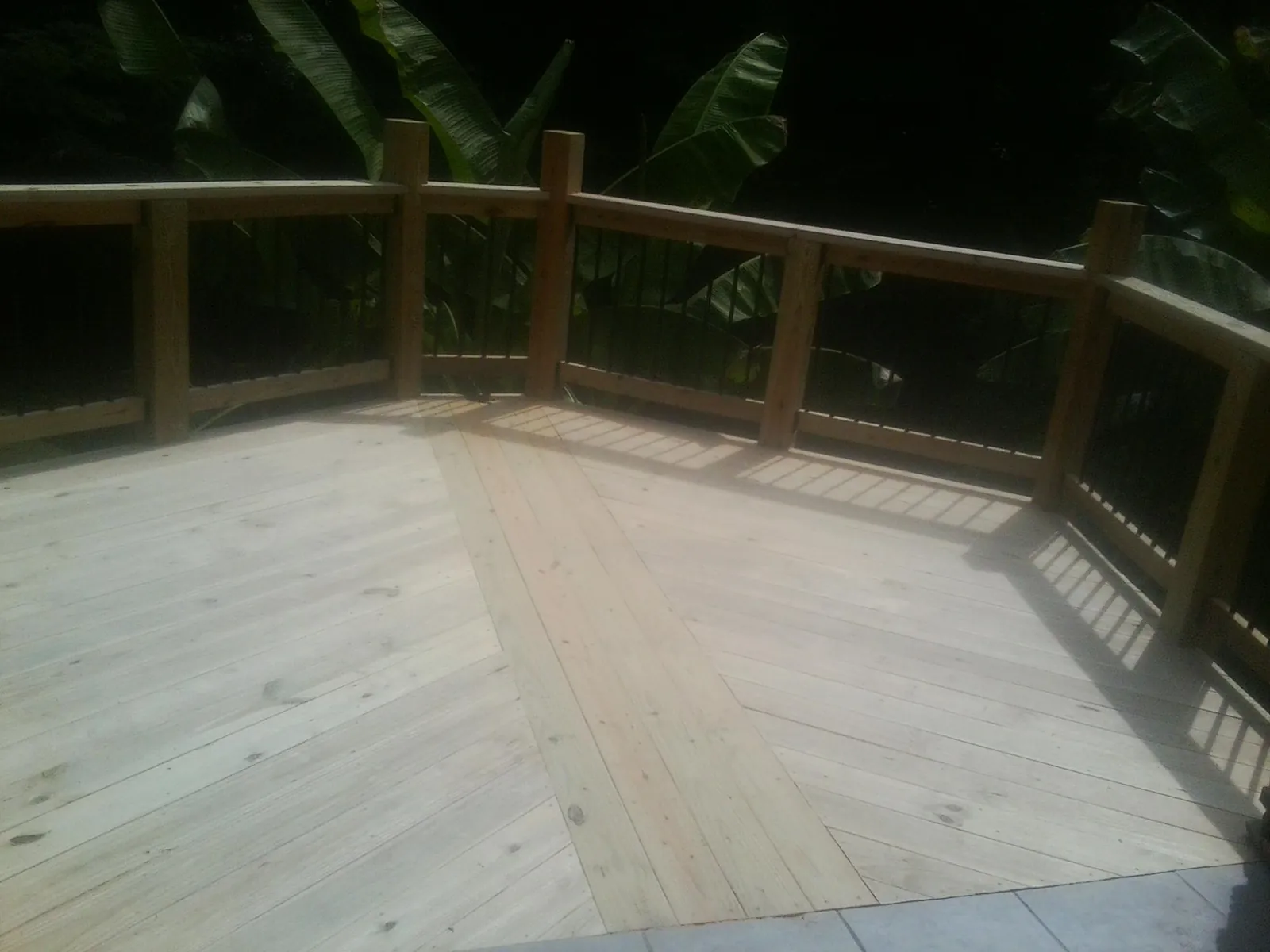 New wood deck and railing built off the back of a home in Salem